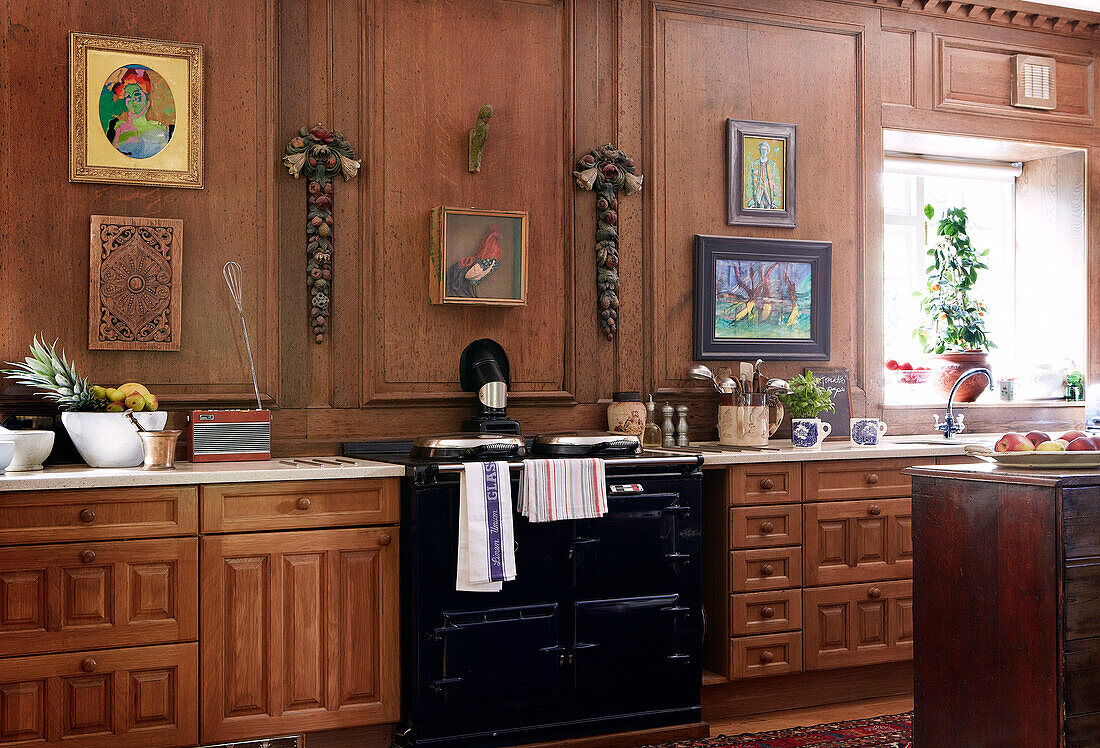 Black AGA in wood panelled kitchen of traditional country house Welsh borders UK