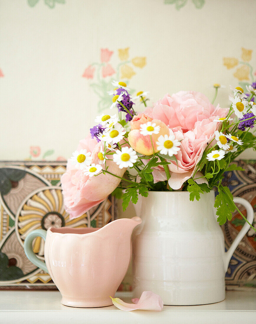 Rosa Rosen und Wildblumen im Keramikkrug in einem Cottage in Devonshire UK