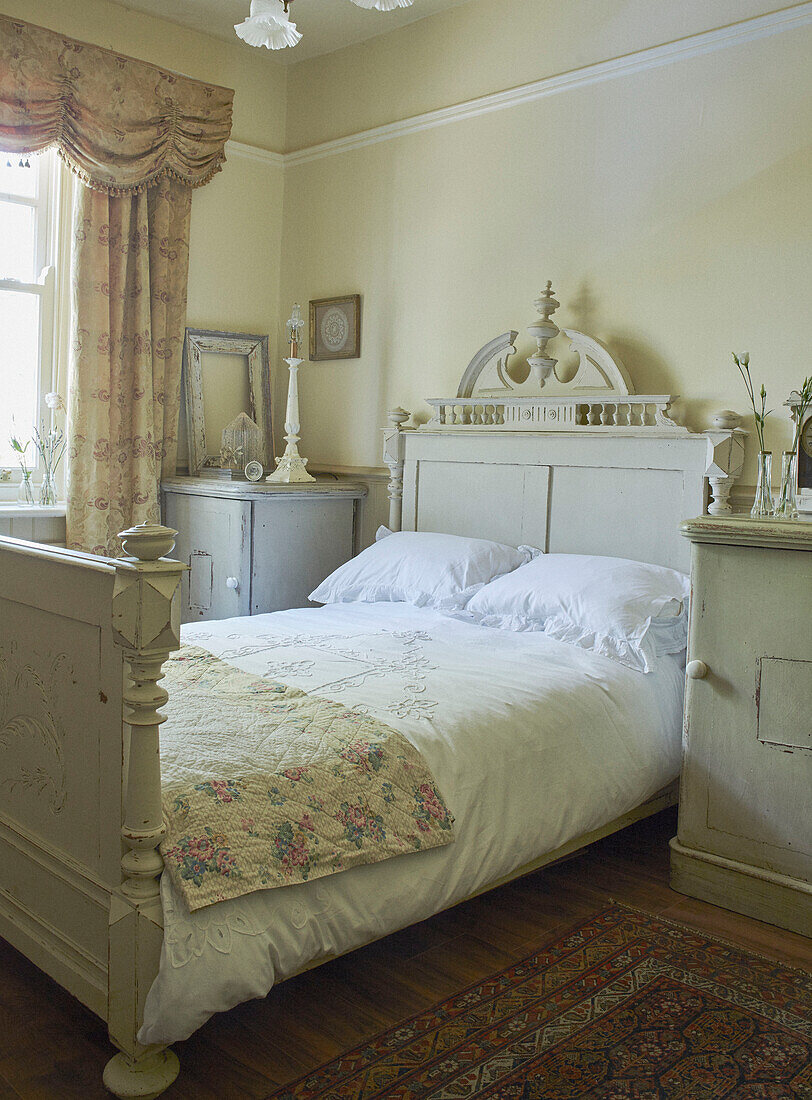 Floral cover on antique double bed in Whitley Bay cottage Tyne and Wear England UK