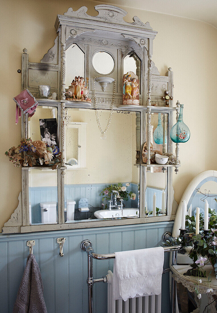 Figurine ornaments and dried flowers on vintage wall-mounted shelving in Whitley Bay bathroom Tyne and Wear England UK