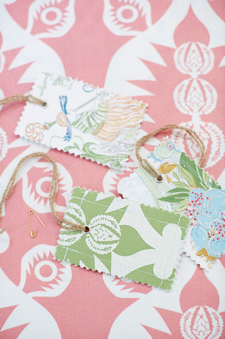 Gift tags on string with pink design in Northumbrian textiles studio England UK