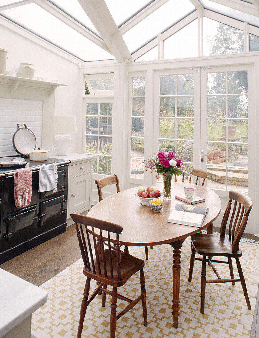 Oval table and black AGA in conservatory kitchen extension Bicester Oxfordshire England