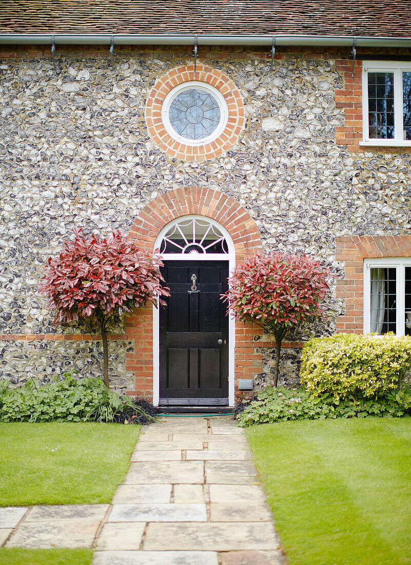 Porthole window above black painted front door of Buckinghamshire home UK