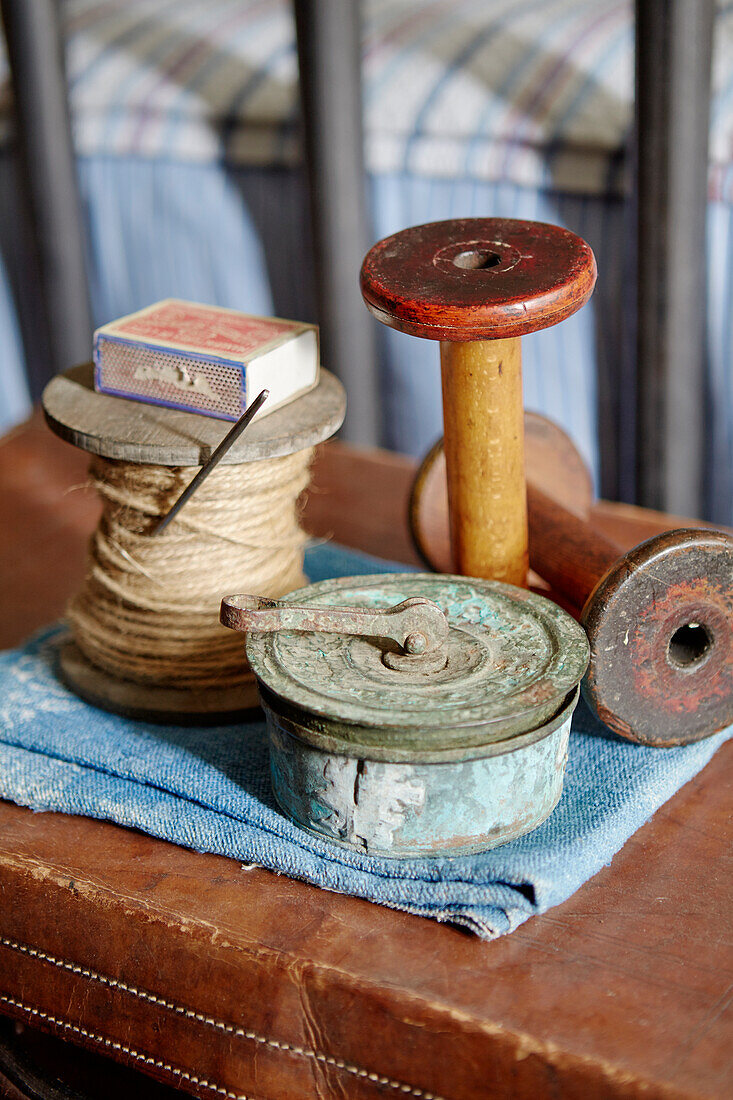 Wooden spools and metal tin with matchbox in Sunderland home Tyne and Wear England UK