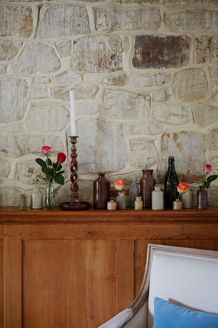 Collection of vases and exposed stone wall in Kent home, North East England, UK