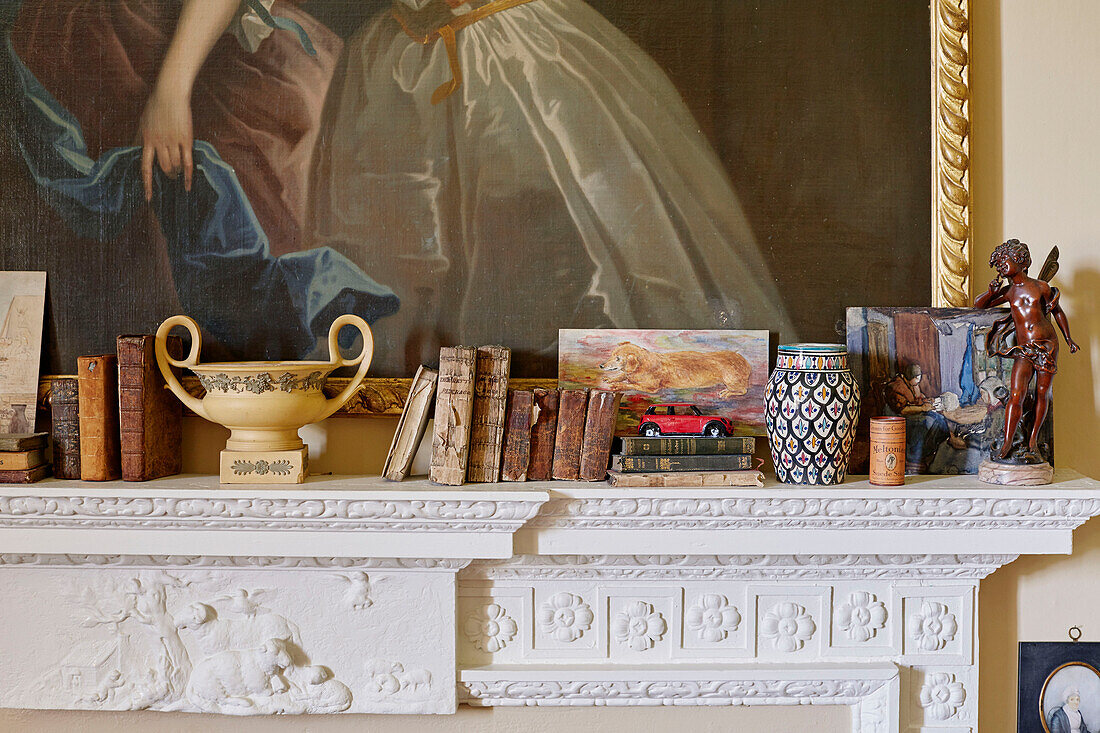 Book and ornaments on mantlepiece in Capheaton Hall, Northumberland, UK