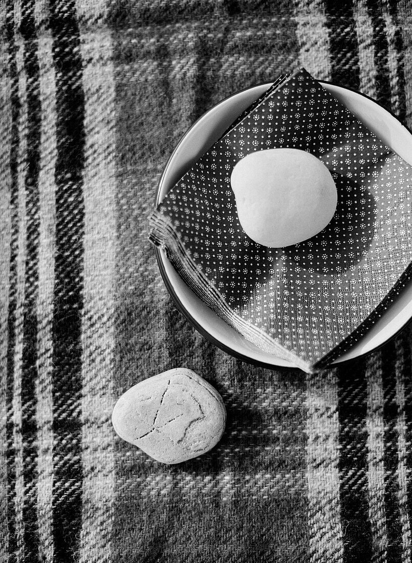 Pebble weighting napkins in bowl on tartan tablecloth County Sligo Connacht Ireland
