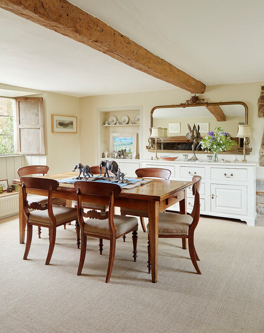 Wooden dining table and chairs in Oxfordshire cottage, UK
