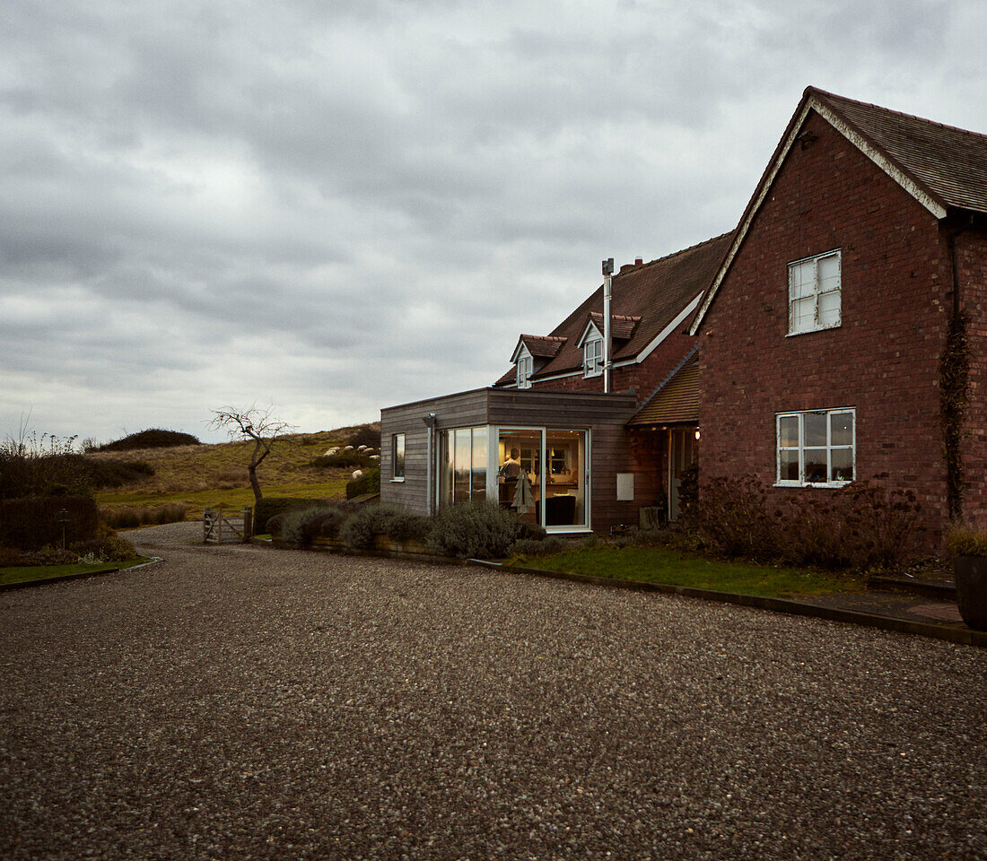 Gravel driveway at exterior of Worcestershire farmhouse, England, UK