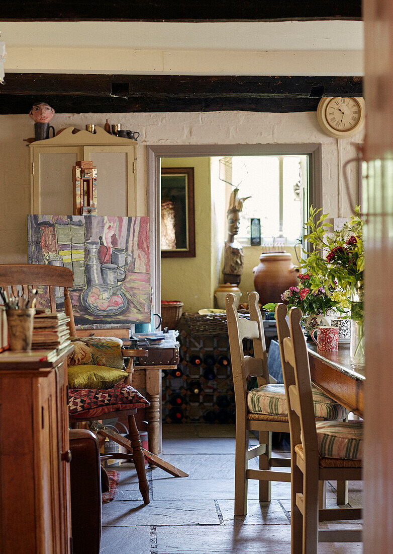 Artwork and wooden furniture in Powys cottage dining room, Wales, UK