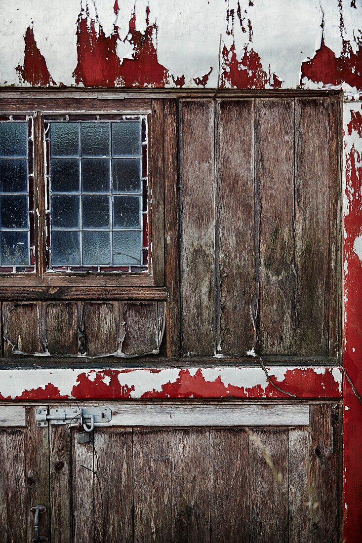 Peeling paint and wooden door with leaded glass window in Radnorshire-Herefordshire borders