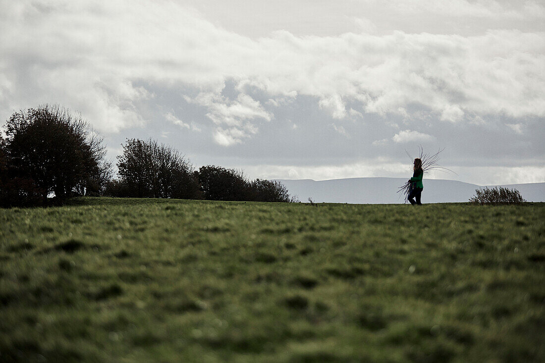 Woman walking near Offas Dyke path in rural Radnorshire-Herefordshire borders, UK