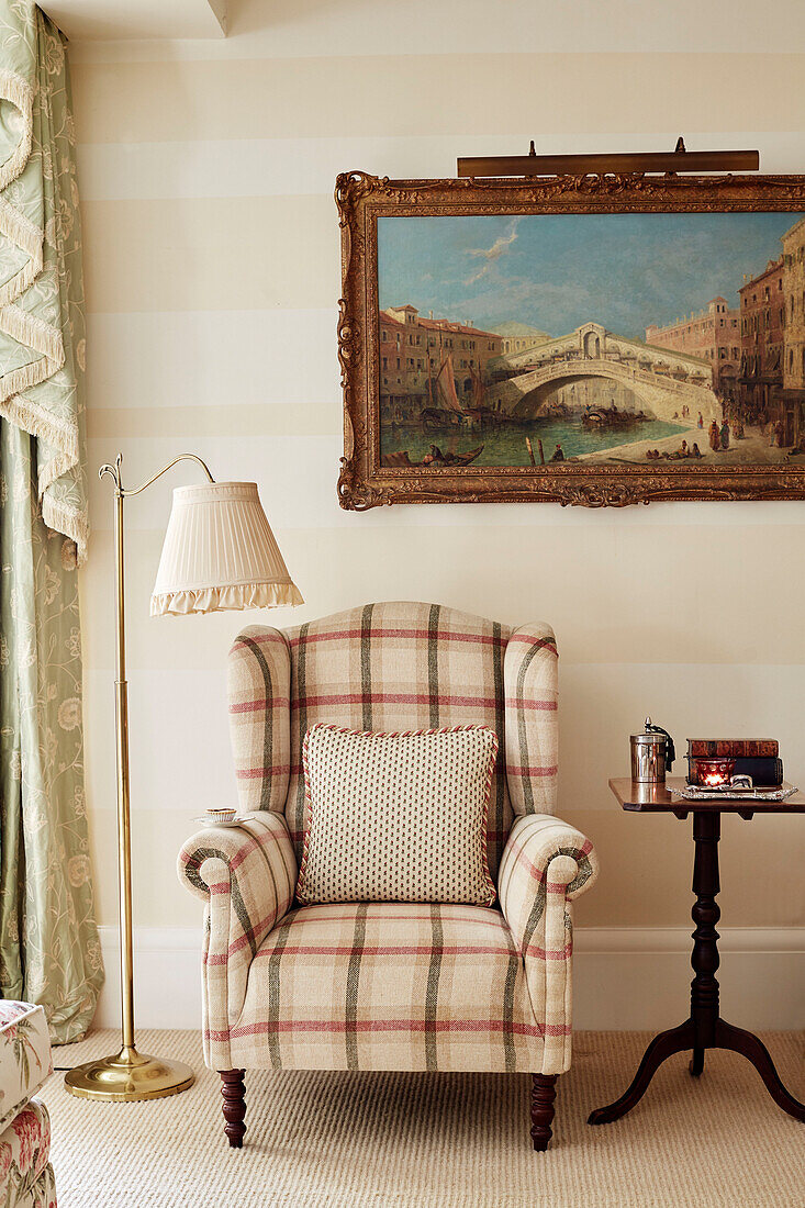 Upholstered armchair and artwork of Rialto bridge in Cotswolds home, UK
