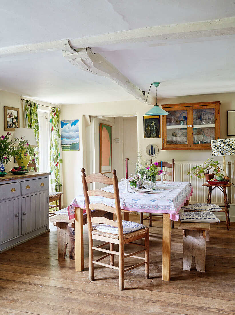 Wooden benches and chair at table in Oxfordshire farmhouse, UK