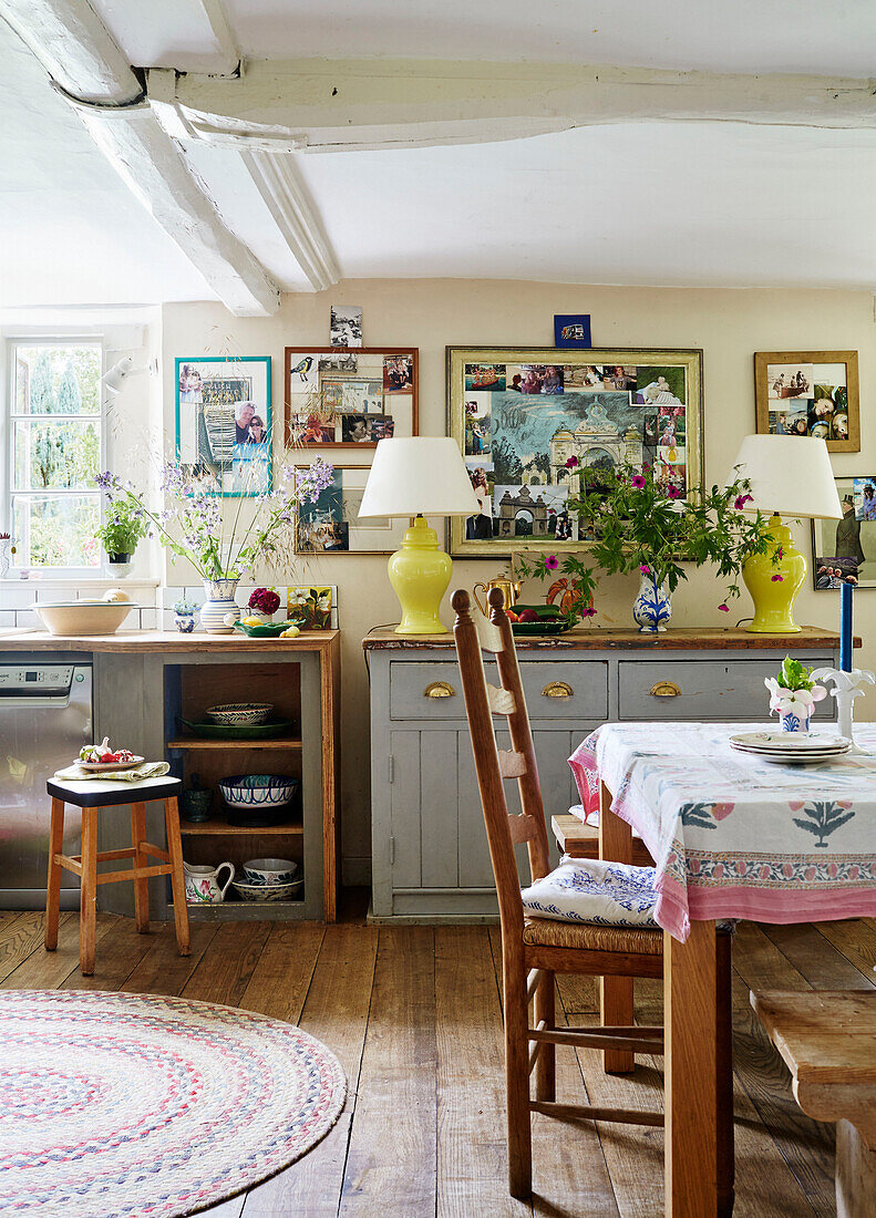 Chair and table with pinboards and lamps in Oxfordshire kitchen, UK