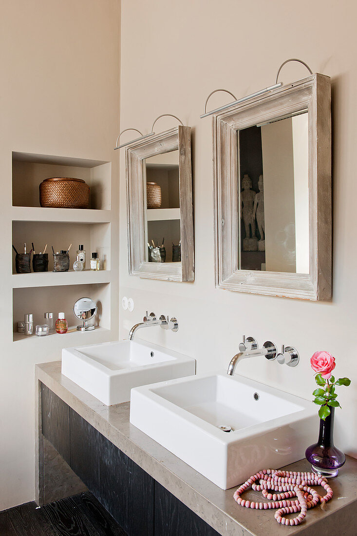 Zwei Spiegel über eckigen Doppelwaschbecken im Bad in Beige