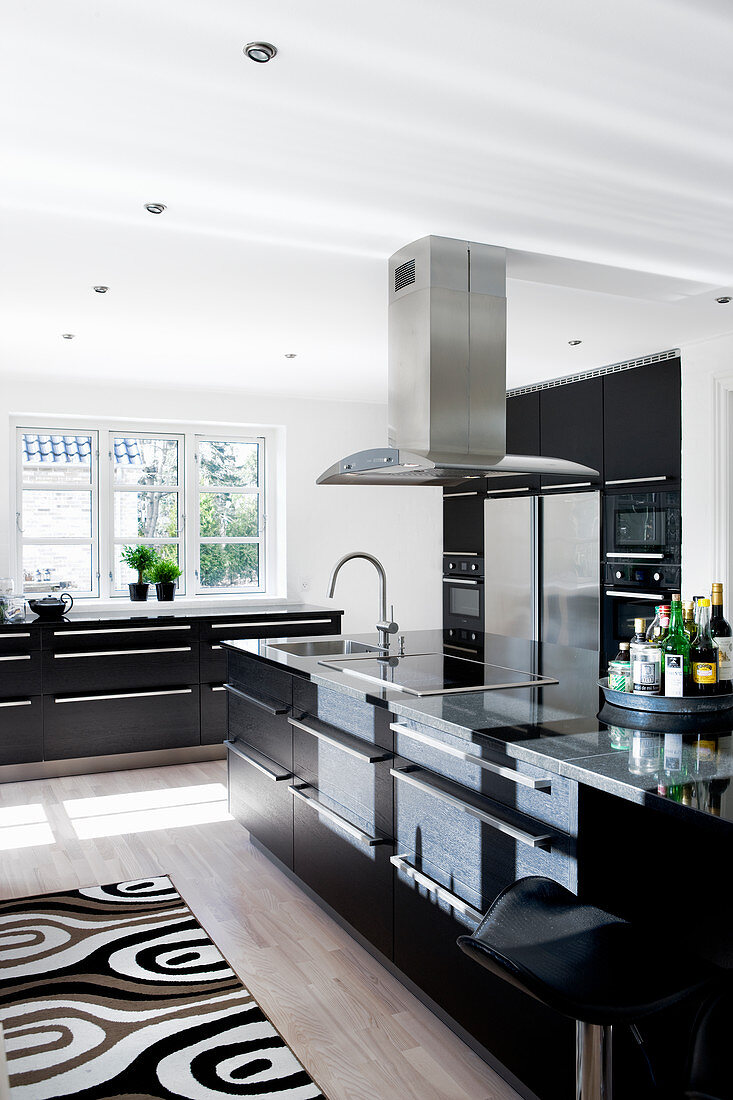 Black fitted cabinets in large modern kitchen