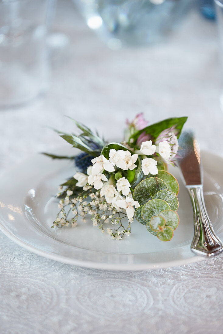 Small plate bouquet made of waxflower, eucalyptus, and gypsophila
