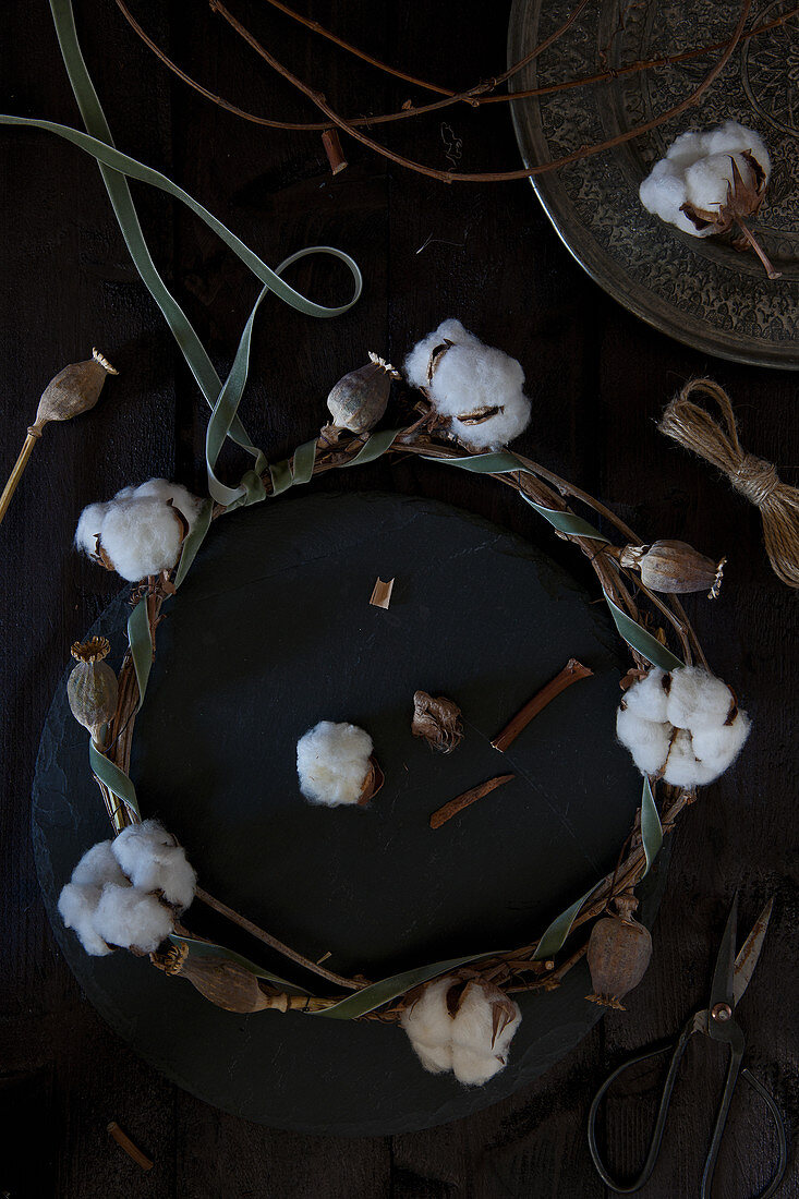 Wreath of cotton bolls, poppy seed heads and velvet ribbon