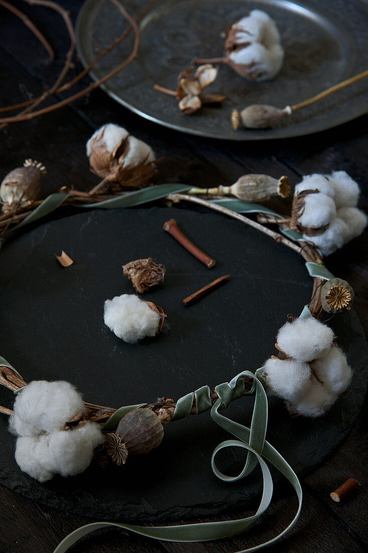 Wreath of cotton bolls, poppy seed heads and velvet ribbon