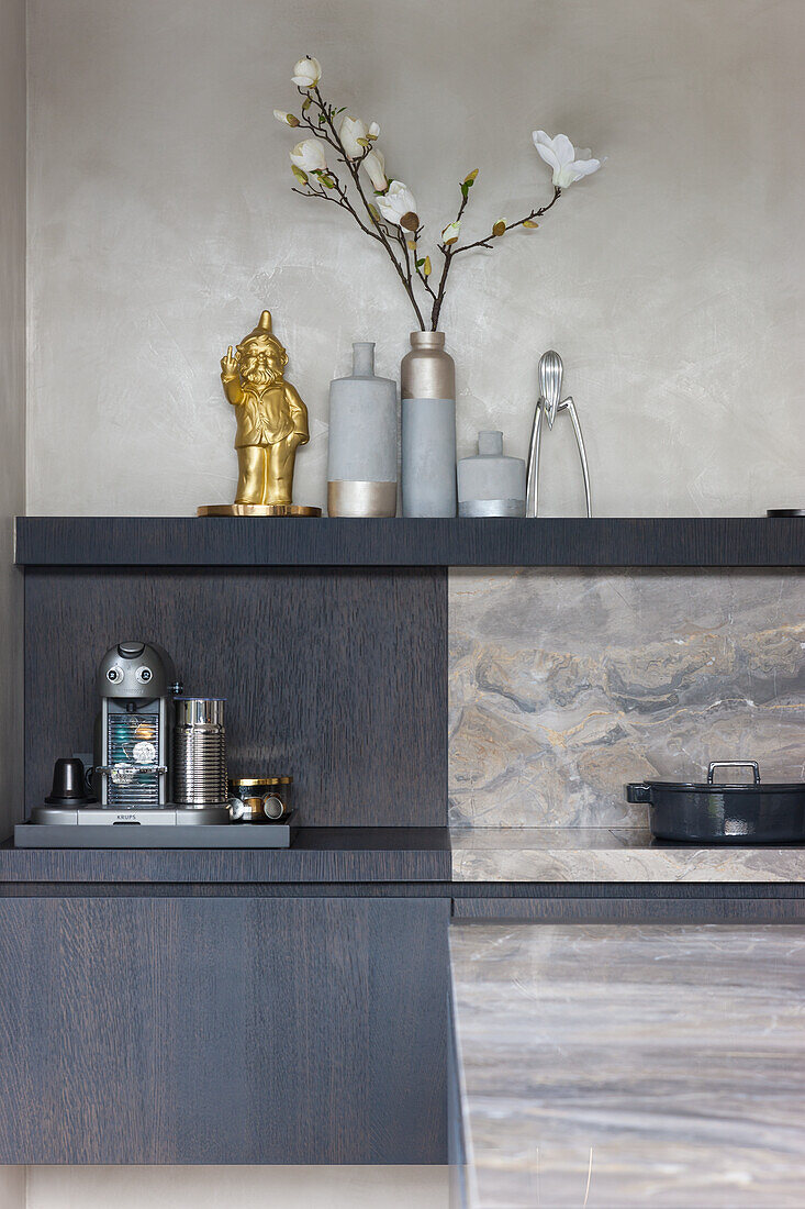 Kitchen unit in dark wood with dwarf figurine and modern vases