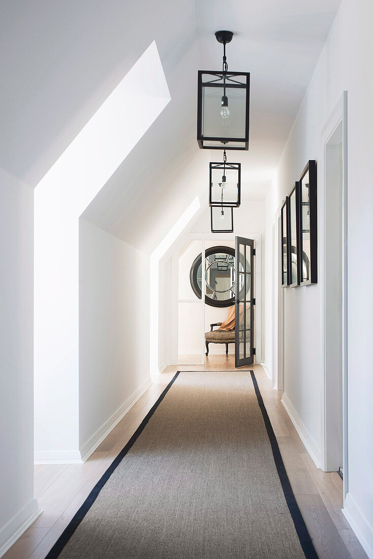 Lanterns hang in the classic style hallway with pitched roof and runner