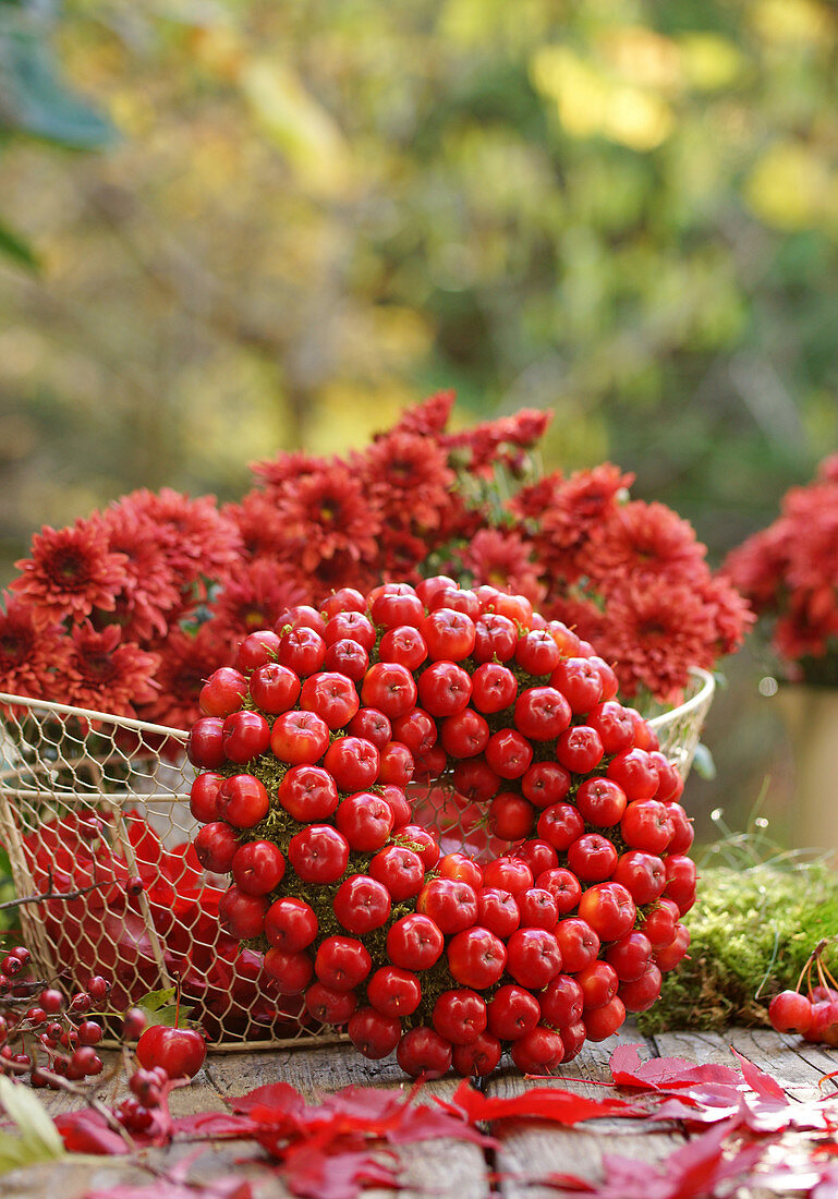 Wreath of crab apples and basket of chrysanthemums