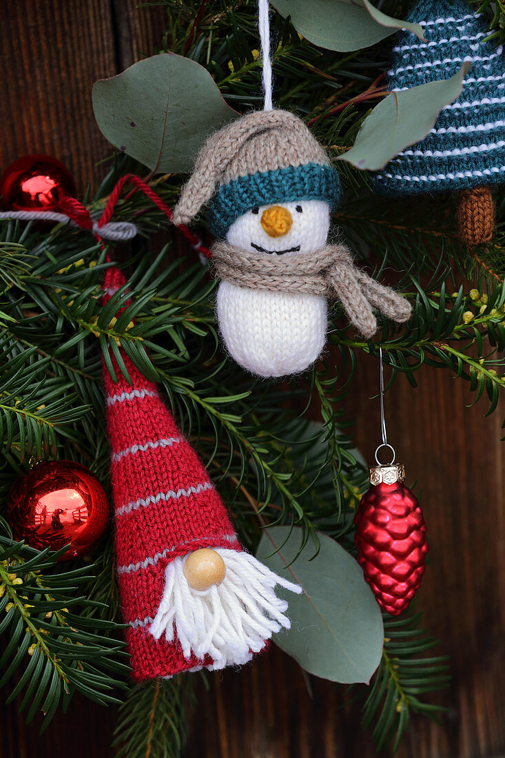 Knitted winter decorations in shapes of gnome and snowman