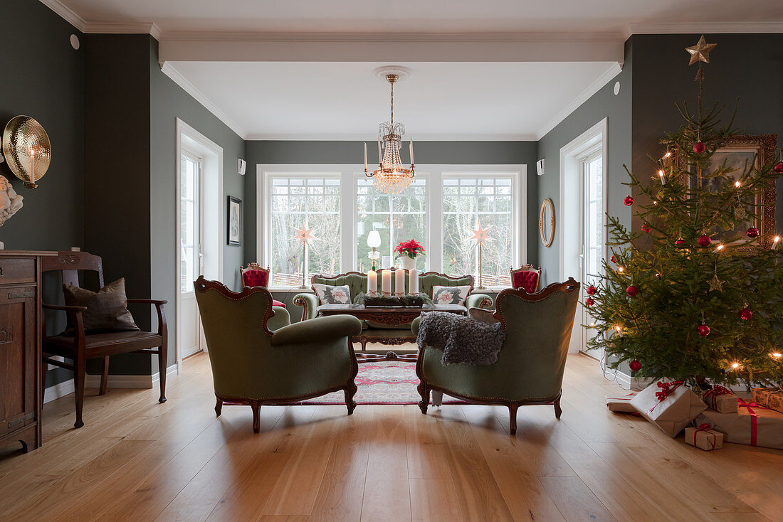 Antique furniture and Christmas tree in classic living room