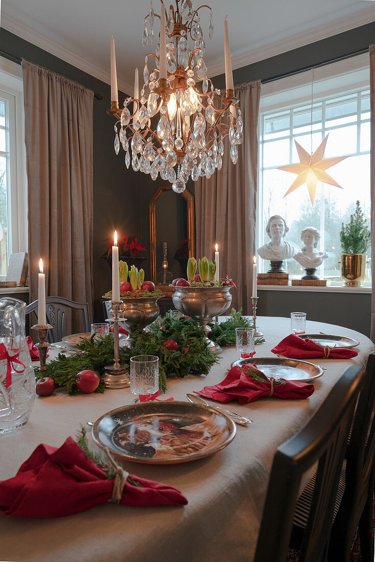 Festively set table in classic dining room decorated for Christmas