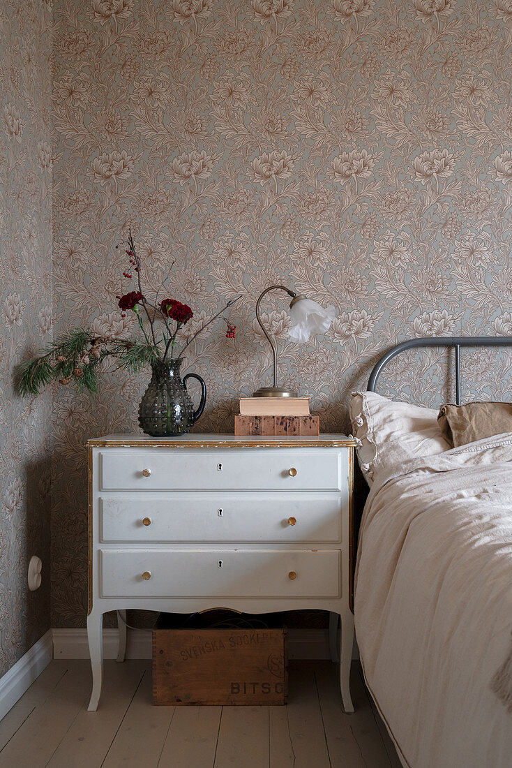 Vintage-style bedside cabinet in granny-chic bedroom