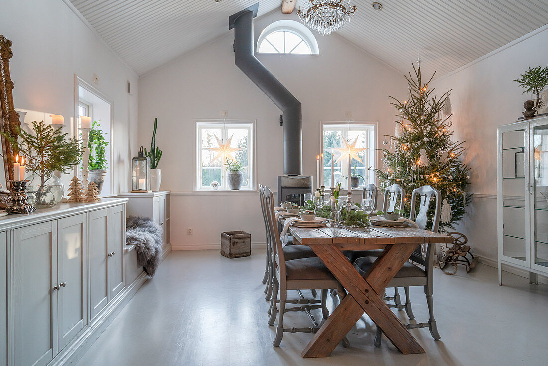 Festively set table in classic dining room with high ceiling