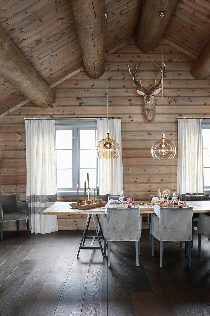 Set table in dining room of elegant log cabin