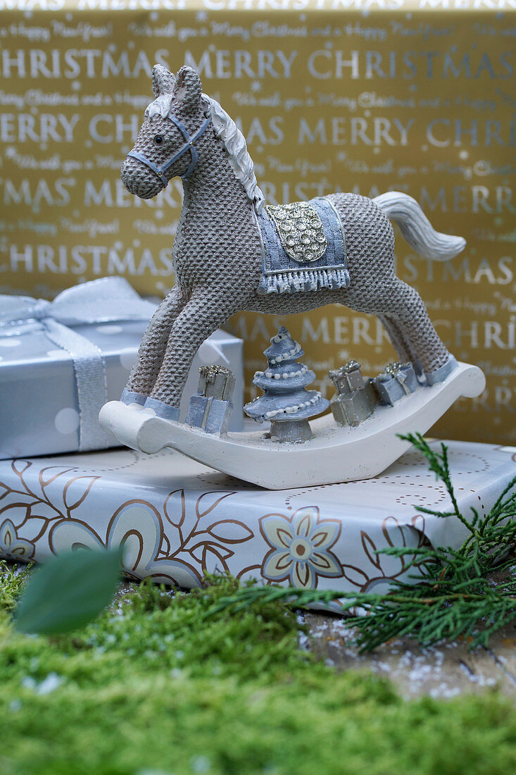 Ornamental rocking horse on wrapped present
