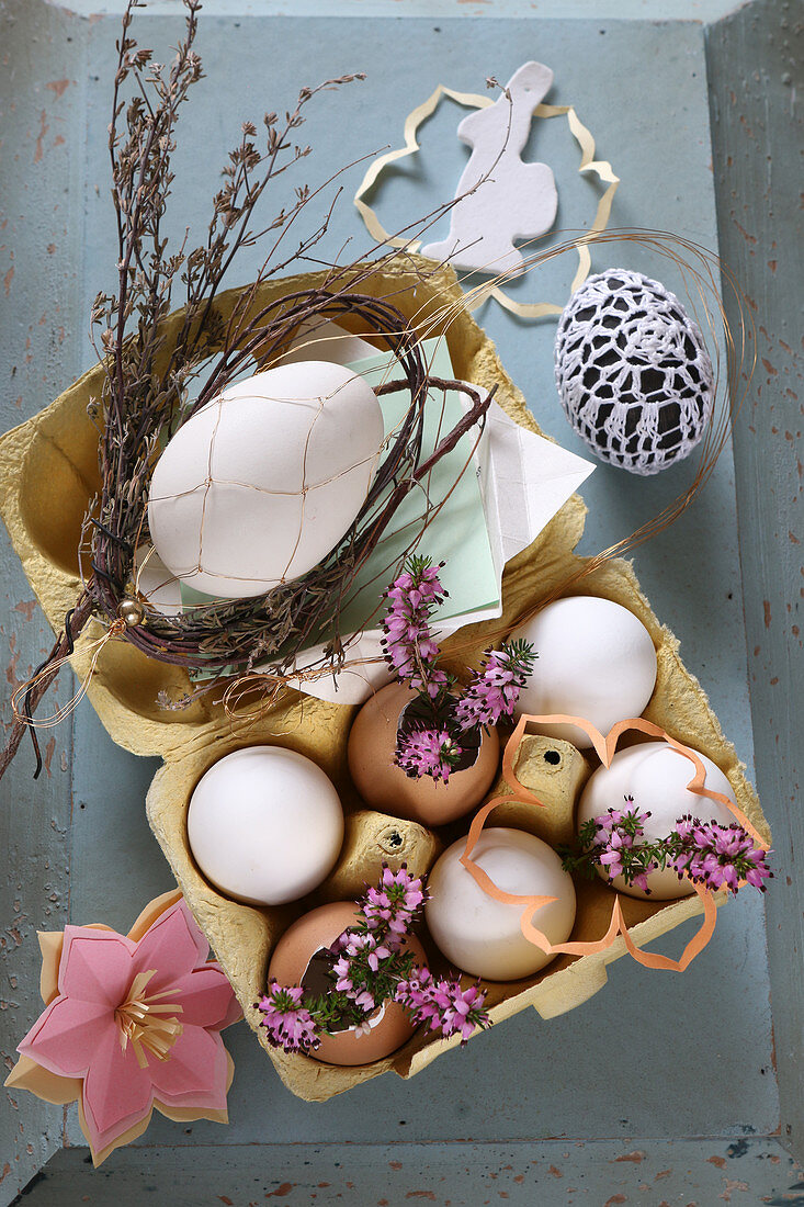 Romantic Easter arrangement with heather and eggs in egg box