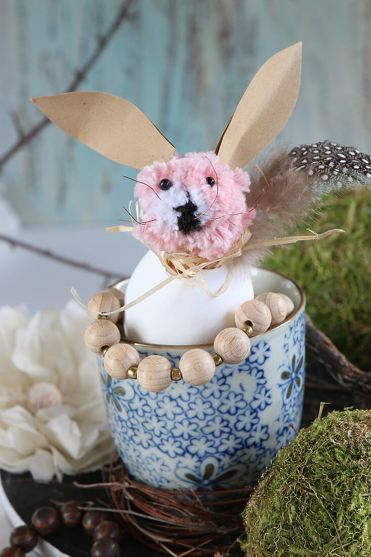Easter bunny made from pompom, egg shell and paper in mug