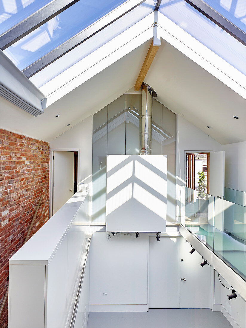Gallery and glass pitched roof in architect-designed house