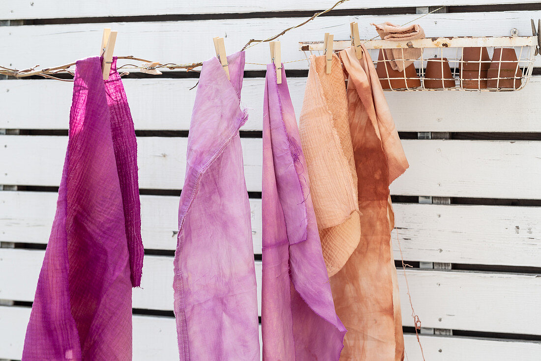 Fabrics coloured using natural dyes and hung up to dry