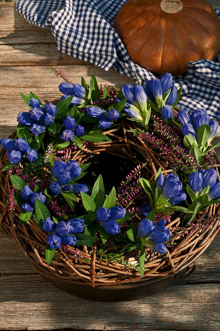 Closed Gentiana with budding heather and twigs tied to a wreath