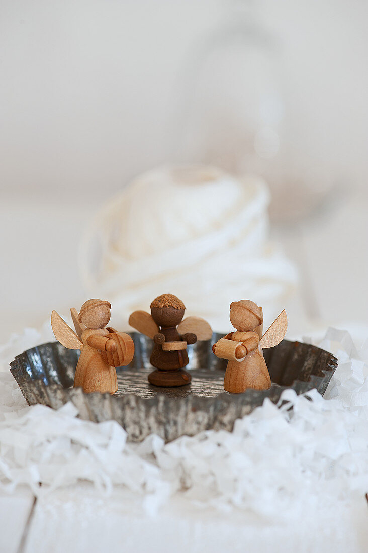 Wooden angels in a small baking pan