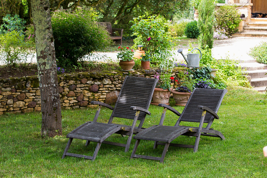 Two loungers on lawn in garden