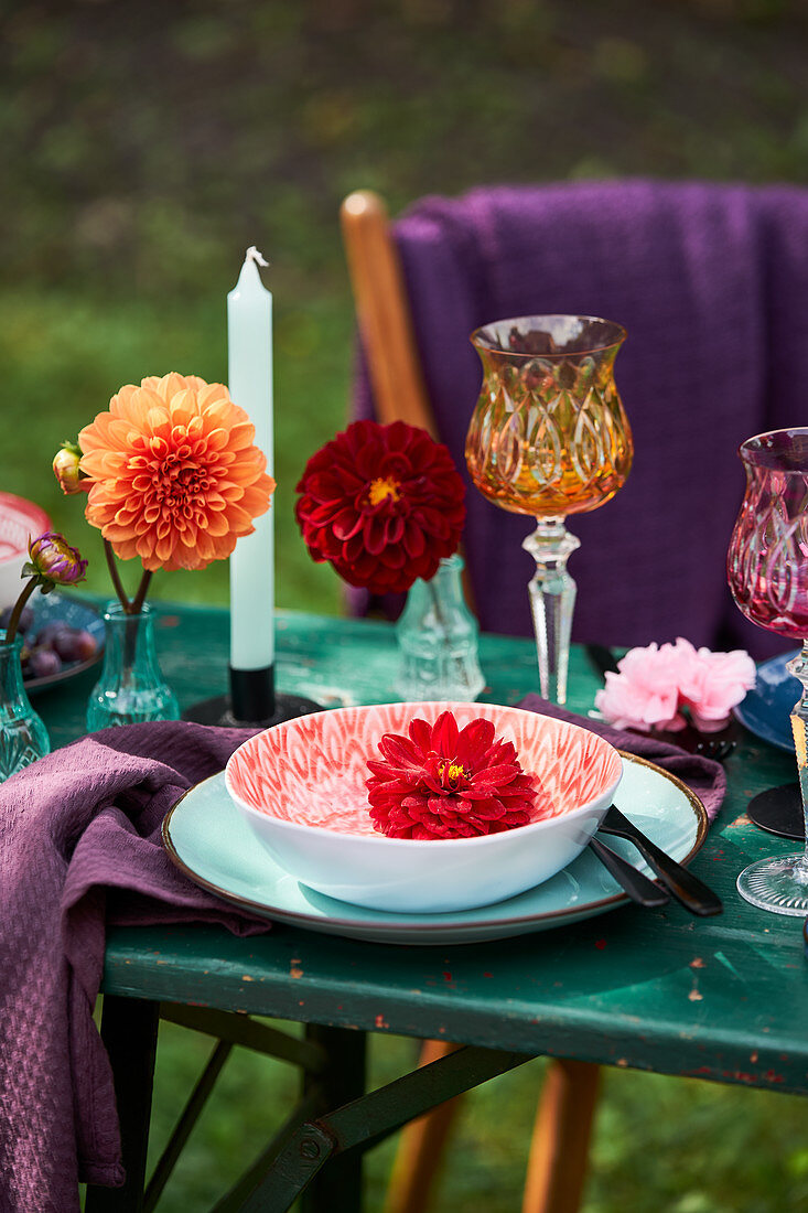 Place setting decorated with dahlias outdoors