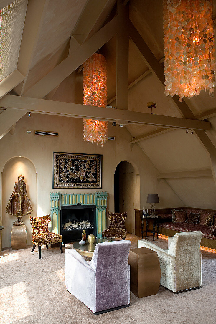 Seating area with fireplace, chandelier and artworks in attic room