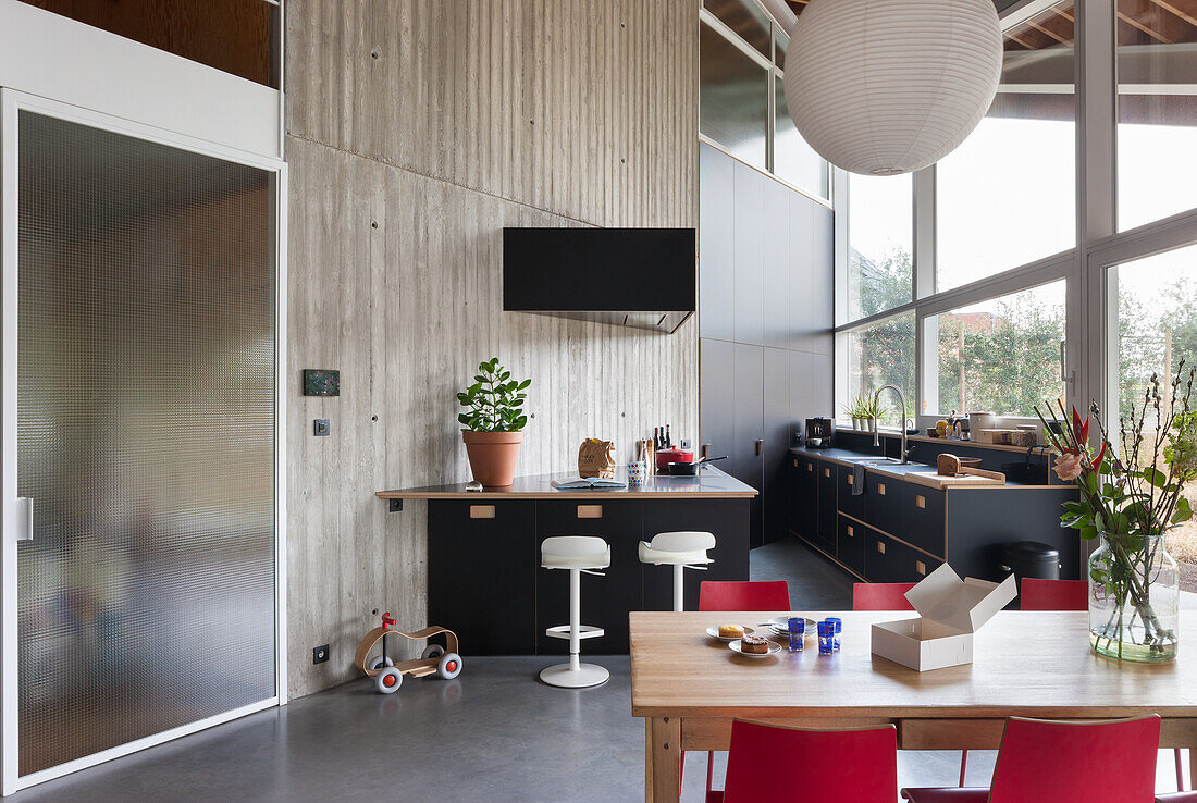 Modern kitchen with black cabinets and open-plan dining area