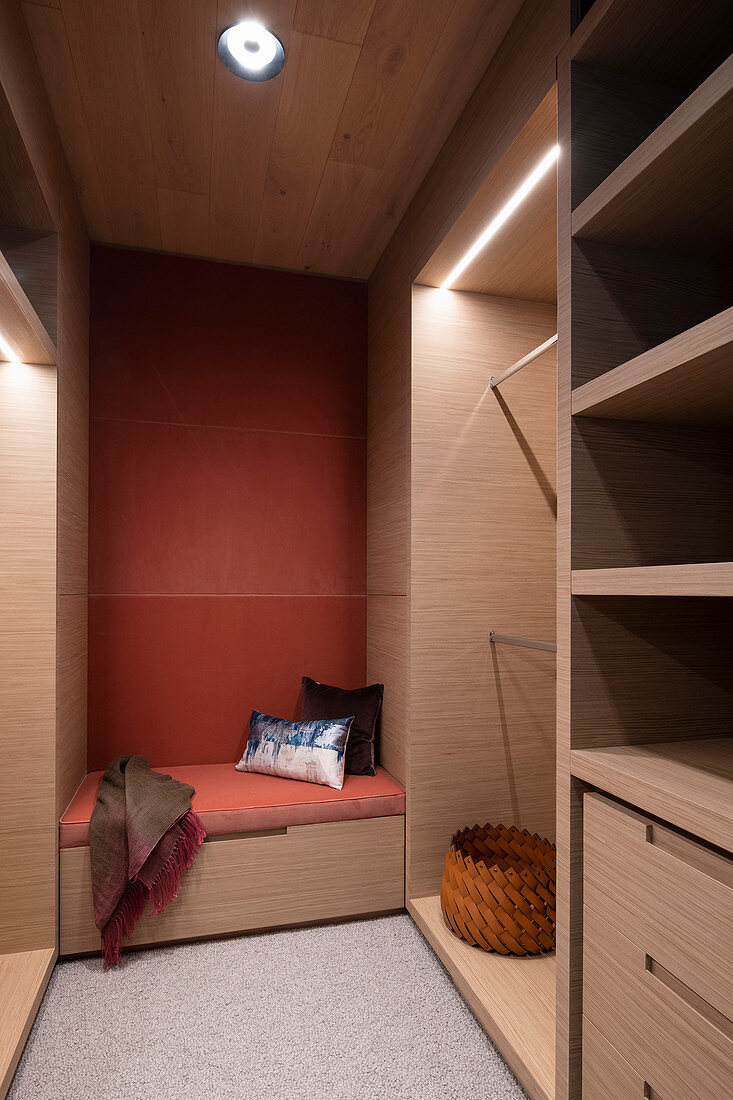 Couch in walk-in wardrobe with lighting