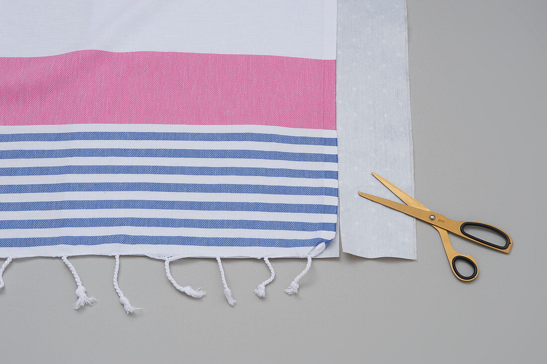 Striped cloth, oilcloth and scissors