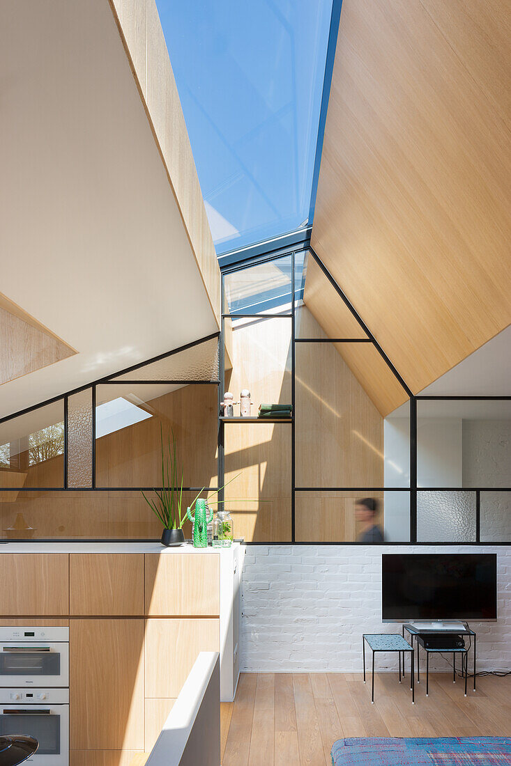 Modern living room with wooden elements and large skylight