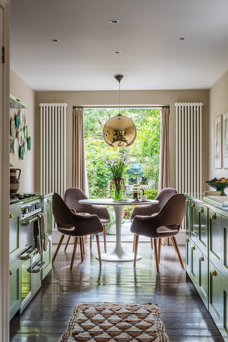 A 1960s style kitchen with a dining area in a Victorian house
