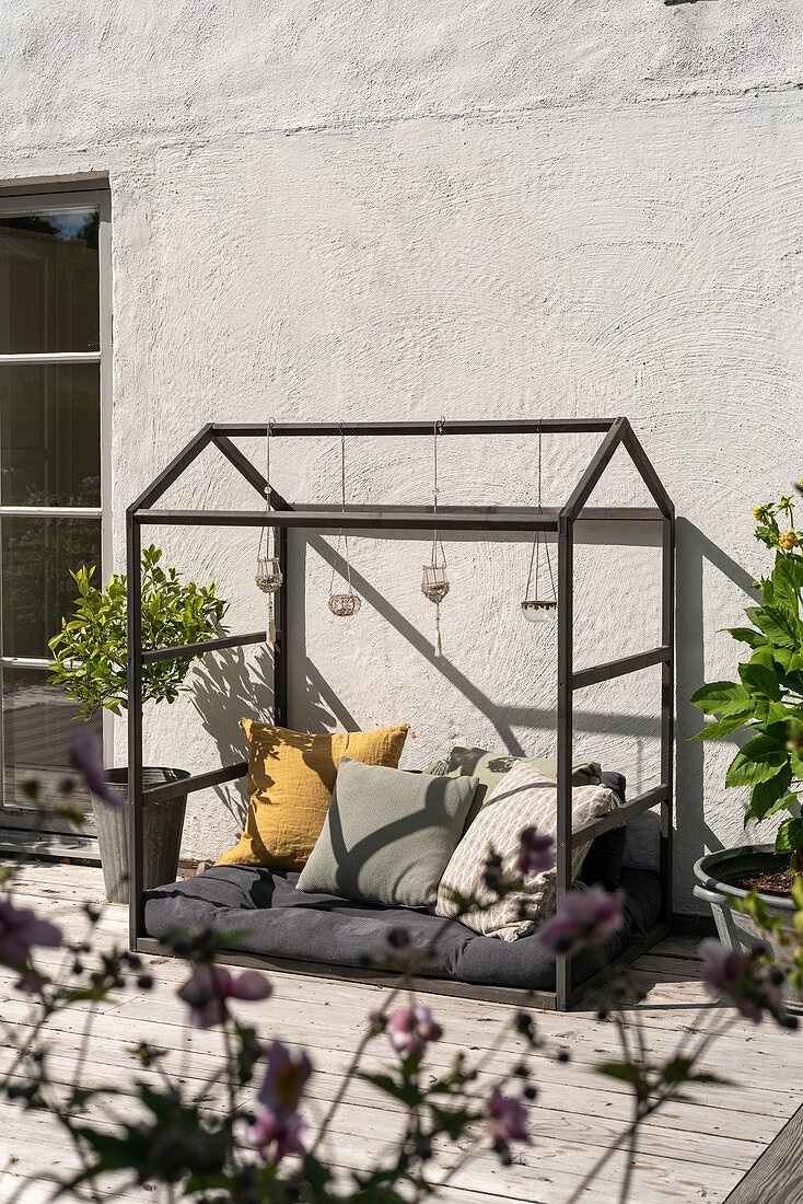 A playhouse made from an old flower case on a terrace