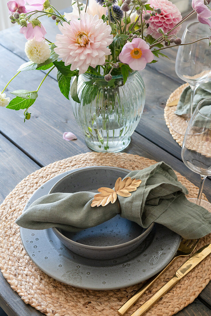 A place setting and a bouquet on a patio table